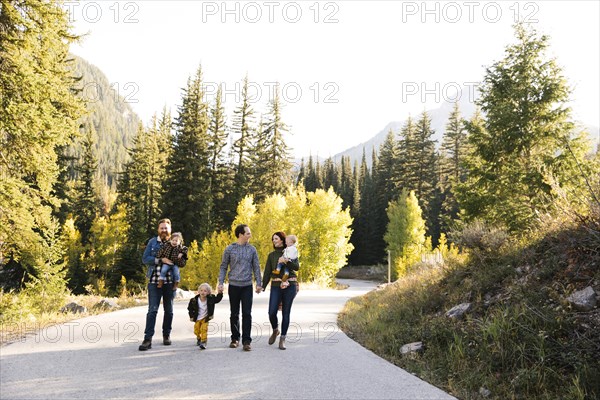 Family and friends on road through forest