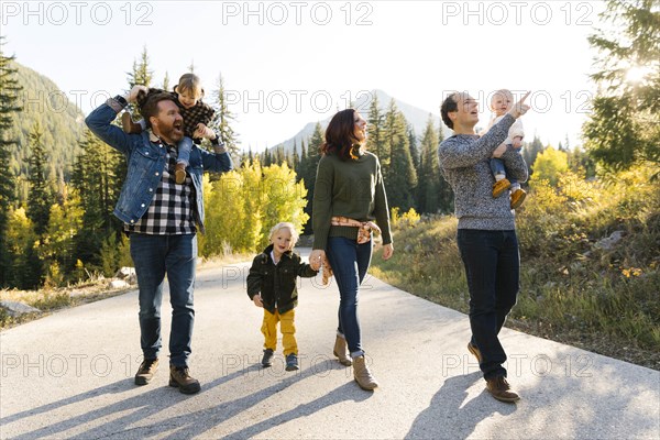 Family and friends on road through forest