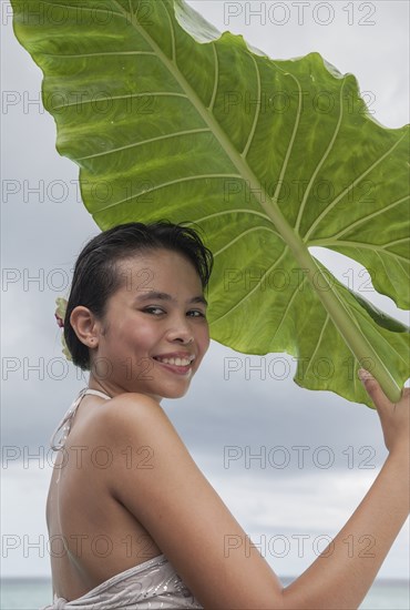 Woman holding big leaf