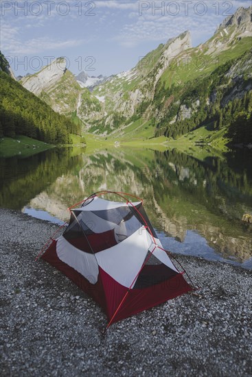 Tent by Seealpsee lake in Appenzell Alps, Switzerland