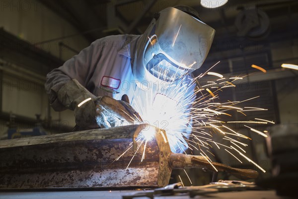 Man welding with sparks flying