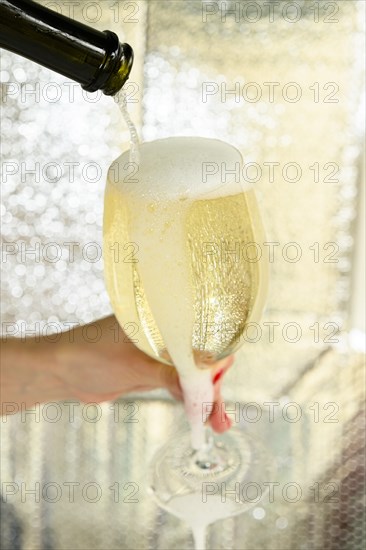 Woman pouring overflowing glass of wine