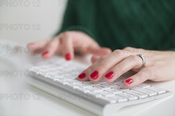 Woman typing on keyboard