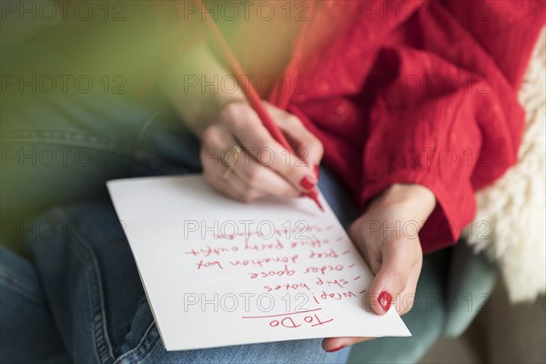 Woman writing 'to do' list