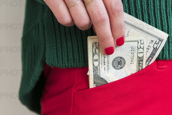 Woman putting money in pocket