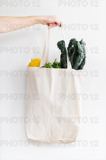 Woman holding bag of vegetables