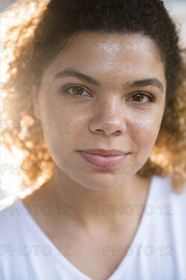 Woman with curly hair looking at camera