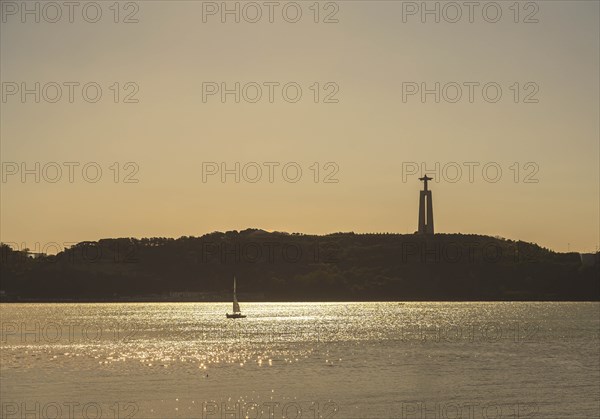 Tagus River with Sanctuary of Christ the King in distance in Lisbon, Portugal