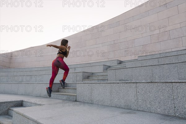 Woman running up steps