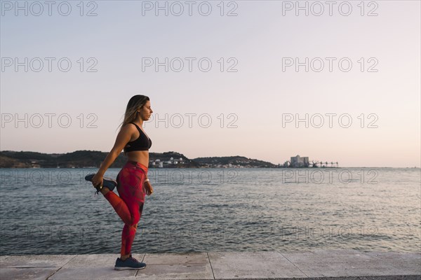 Woman stretching by sea