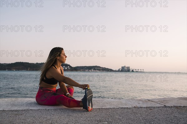 Woman stretching by sea
