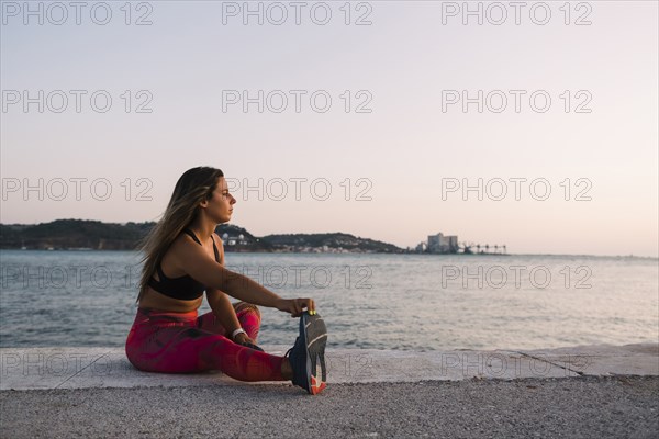 Woman stretching by sea