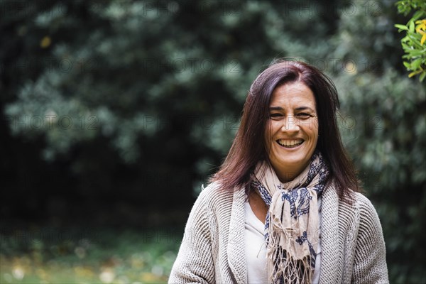 Smiling woman by trees