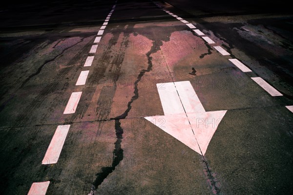 White arrow on wet road