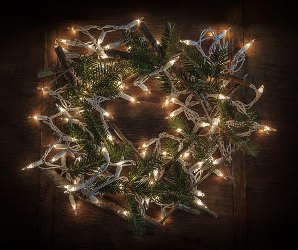 Wreath made from pine fronds, sticks and fairy lights