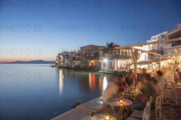 Waterfront restaurants at night in Mykonos, Greece