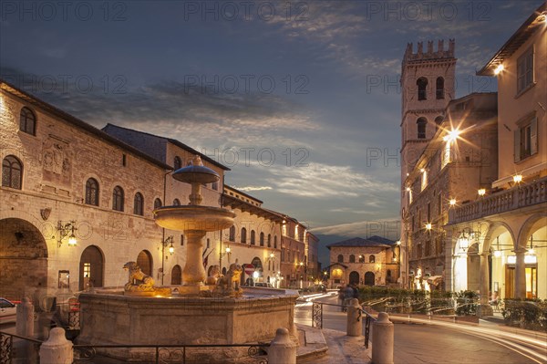 Fountain in Piazza del Comune at sunset in Assisi, Italy