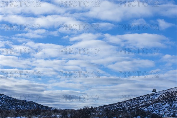Snowy hills under cloud