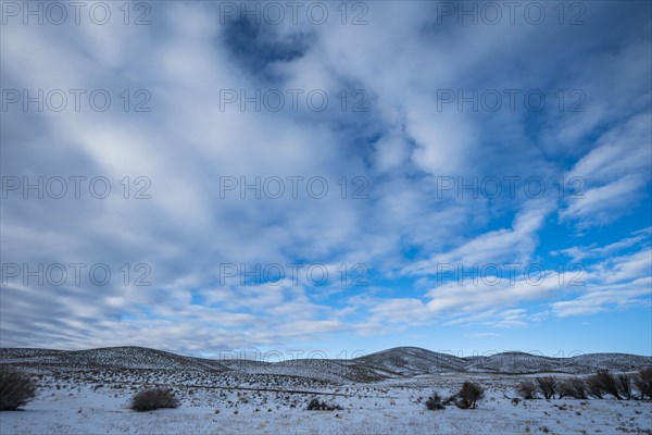 Snowy hills under cloud