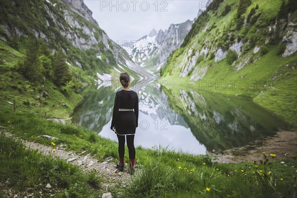 Woman by mountains and lake in Appenzell, Switzerland