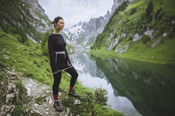 Woman by mountains and lake in Appenzell, Switzerland