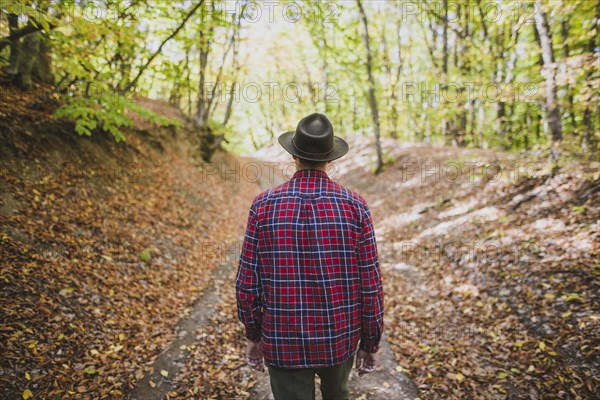 Man wearing red shirt in forest