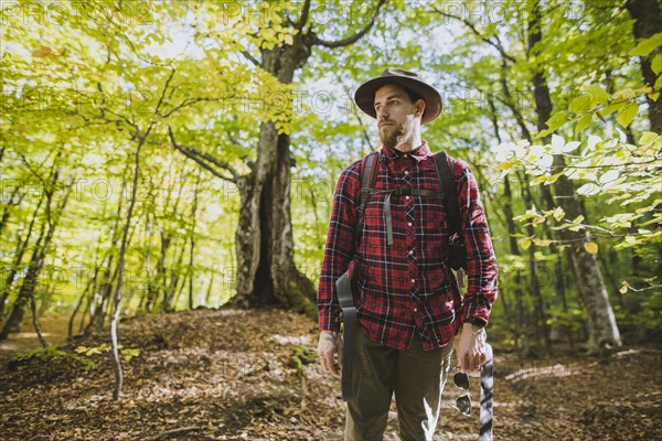 Man wearing red shirt in forest