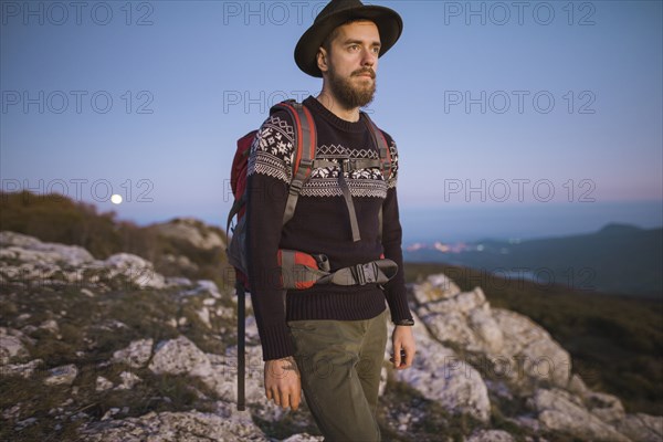 Man against mountain range at sunset