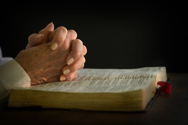 Woman's hands on open bible