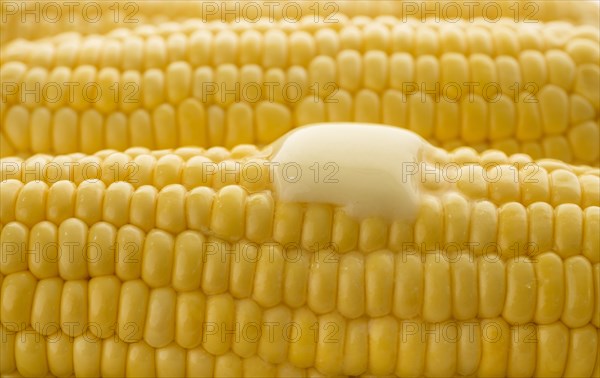 Close up of butter melting on corn cob