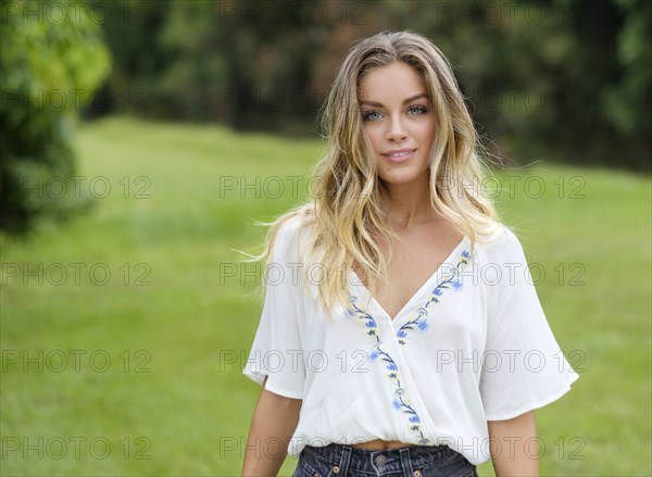 Portrait of young woman in floral pattern blouse