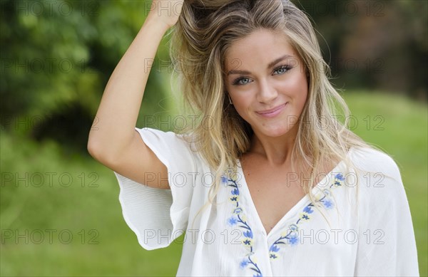 Portrait of young woman with hands in her hair