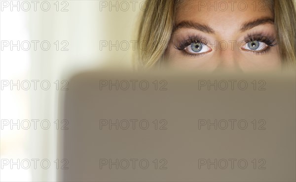 Eyes of young woman using laptop