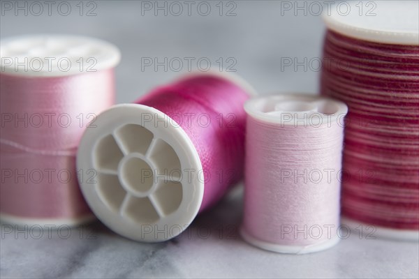 Variety of pink spools of thread