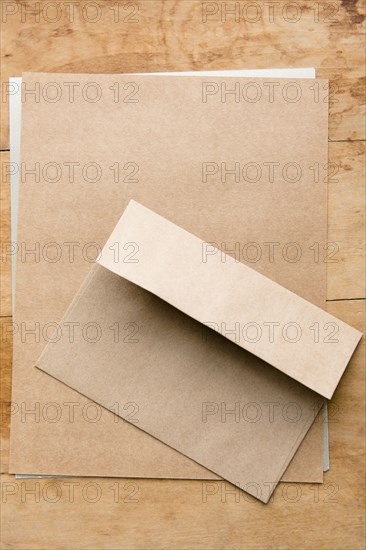 Envelope and paper on wooden table