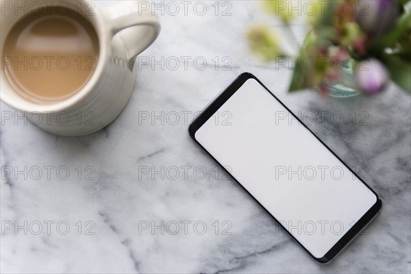 Smartphone and cup of coffee