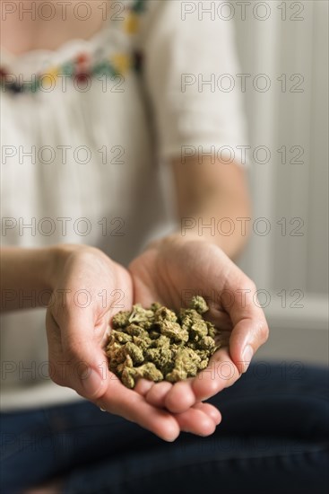 Marijuana in woman's cupped hands