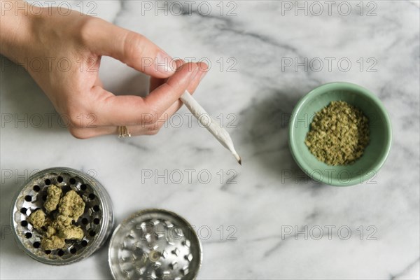 Hand of woman holding marijuana joint