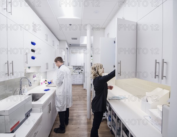 Dentist and assistant in sterilization room