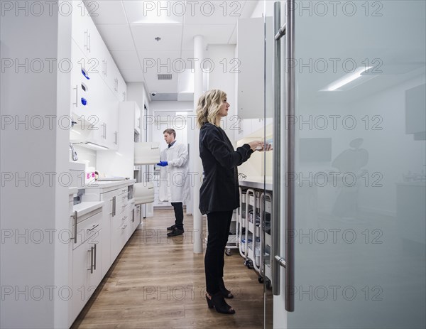 Dentist and assistant in sterilization room