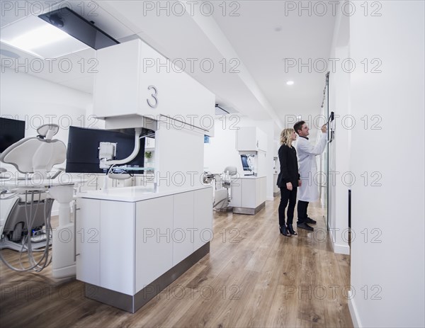 Dentist and assistant in corridor