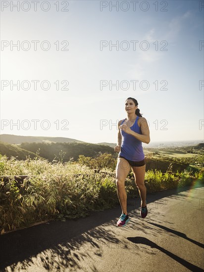 Woman jogging on rural road