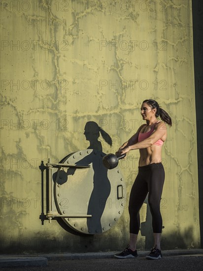 Woman exercising with kettlebell