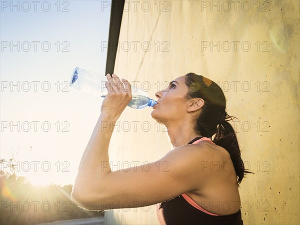 Woman drinking water during exercise break