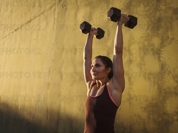 Woman weightlifting with dumbbells