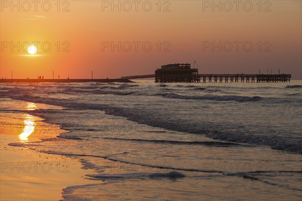 Beach and pier at sunset in Galveston, Texas