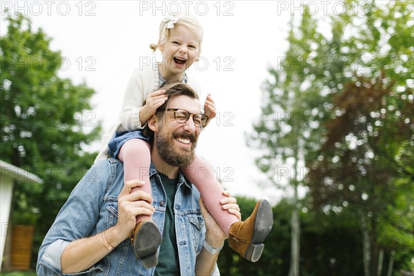 Father giving daughter piggyback ride