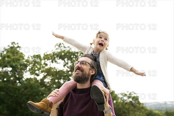 Father giving daughter piggyback ride