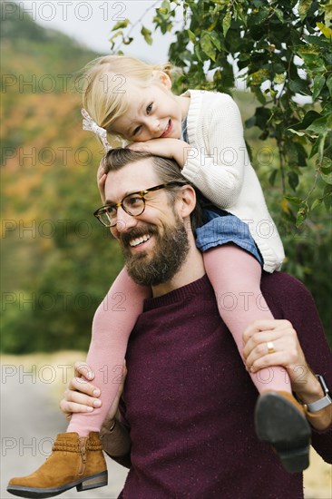 Father giving daughter piggyback ride