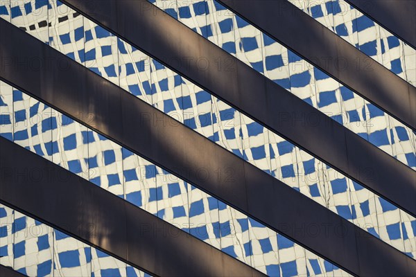 Reflections in window of skyscraper in Denver, Colorado